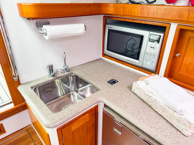 Slide: The Image of Compact kitchen area in a 2012 MJM 40z Downeast boat with sink and microwave. - 26