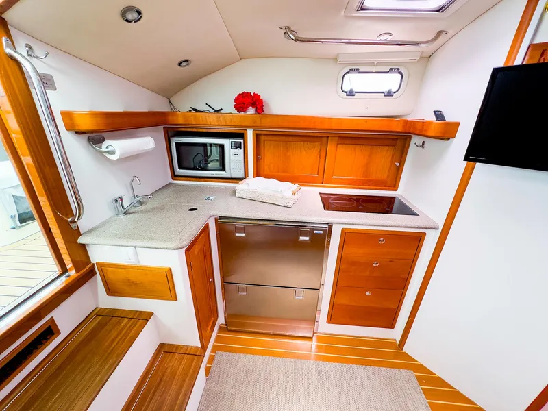 Slide: The Image of 2012 MJM 40z Downeast yacht interior kitchen with modern appliances and wooden cabinetry. - 30