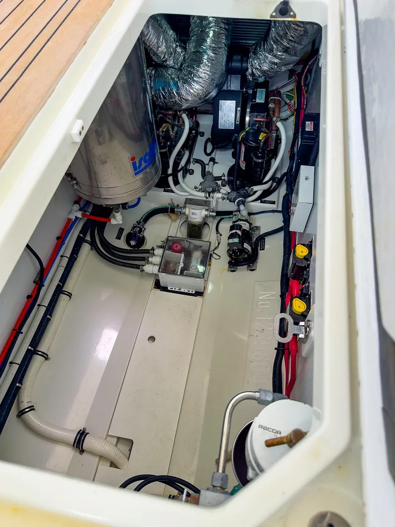 Slide: The Image of Engine compartment of 2012 MJM 40z Downeast boat, showcasing mechanical components and wiring. - 41