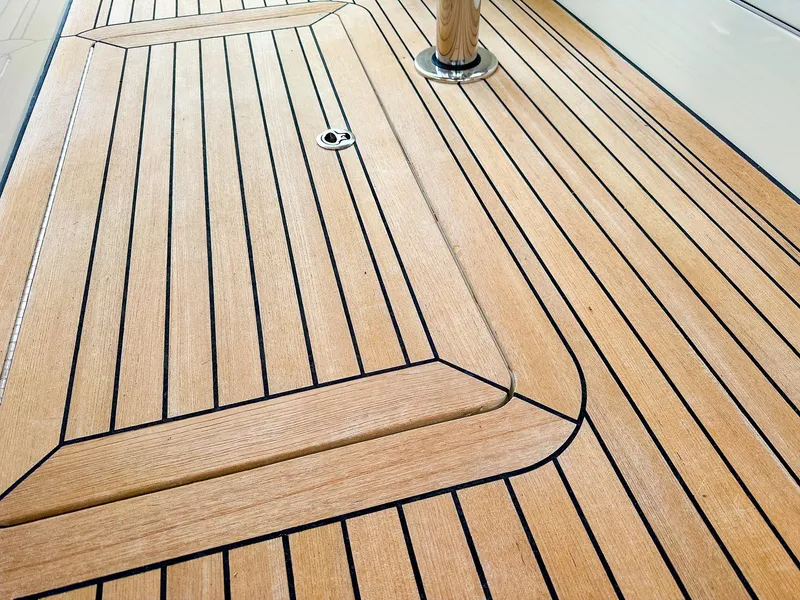 Slide: The Image of Teak deck of 2012 MJM 40z Downeast boat, featuring sleek, polished wood finish. - 9