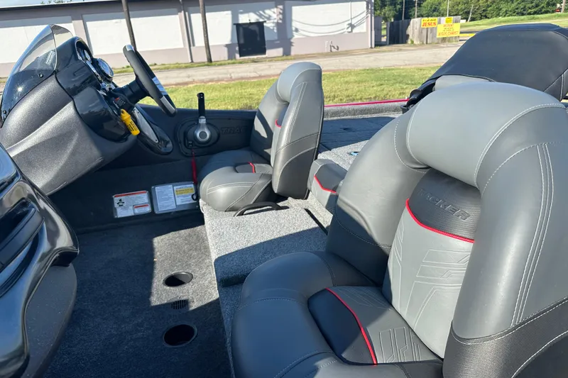 Slide: The Image of 2024 Tracker Pro Team 195 TXW Tournament Edition boat interior with gray seating and steering console. - 10