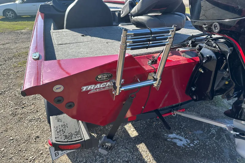 Slide: The Image of 2024 Tracker Pro Team 195 TXW Tournament Edition boat, red exterior, rear view with ladder. - 12