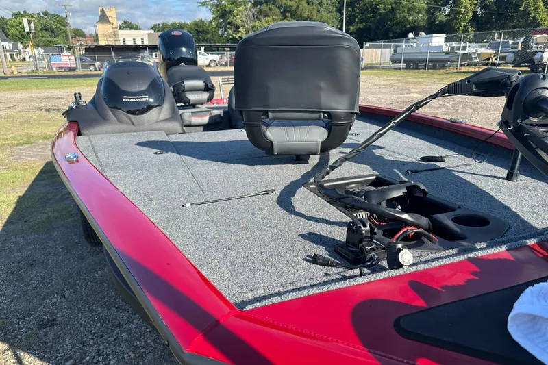 Slide: The Image of 2024 Tracker Pro Team 195 TXW Tournament Edition boat with red exterior and fishing deck. - 17