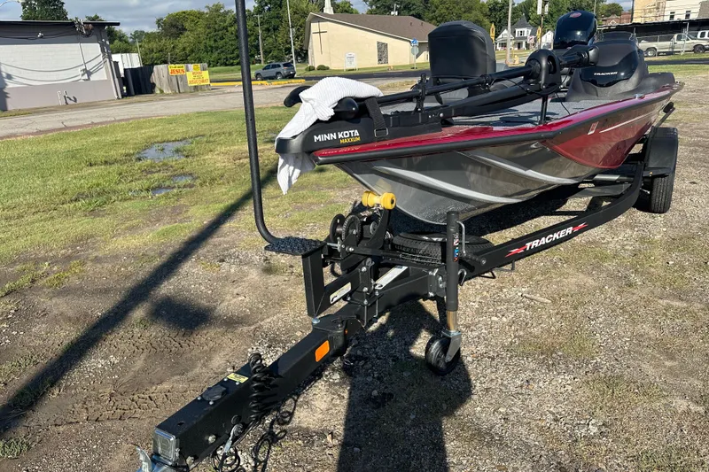 Slide: The Image of 2024 Tracker Pro Team 195 TXW Tournament Edition boat on trailer, parked outdoors. - 6