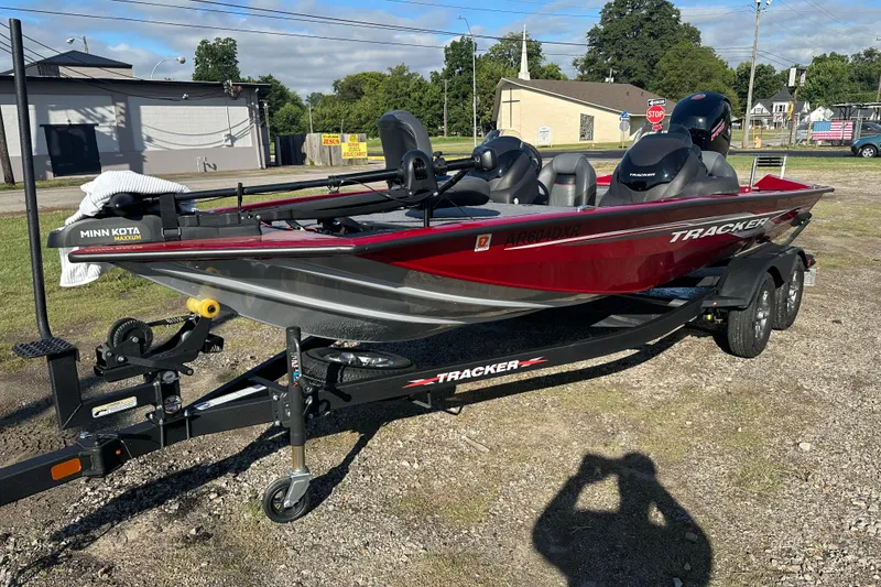 Slide: The Image of 2024 Tracker Pro Team 195 TXW Tournament Edition boat on trailer, parked outdoors. - 7
