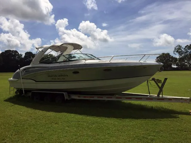 Slide: The Image of 2008 Formula 310 Sun Sport boat on trailer in grassy field under cloudy sky. - 25