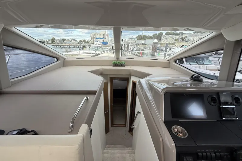Slide: The Image of Interior view of 2018 Sea Ray Sundancer 460 yacht, featuring helm and cabin entrance. - 10