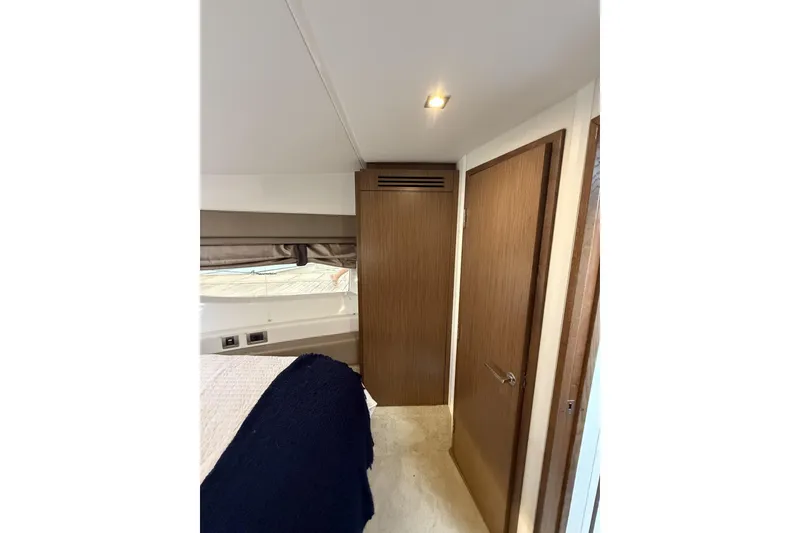 Slide: The Image of Interior cabin of 2018 Sea Ray Sundancer 460 yacht, featuring wood paneling and modern design. - 13