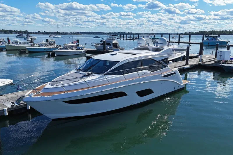 Slide: The Image of 2018 Sea Ray Sundancer 460 yacht docked at marina under blue sky. - 2