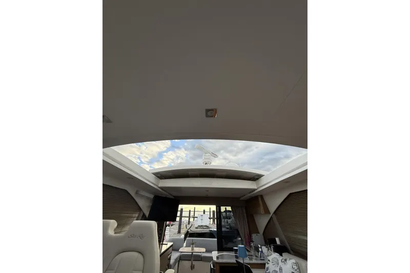 Slide: The Image of Interior view of 2018 Sea Ray Sundancer 460 yacht with open sunroof and modern furnishings. - 22