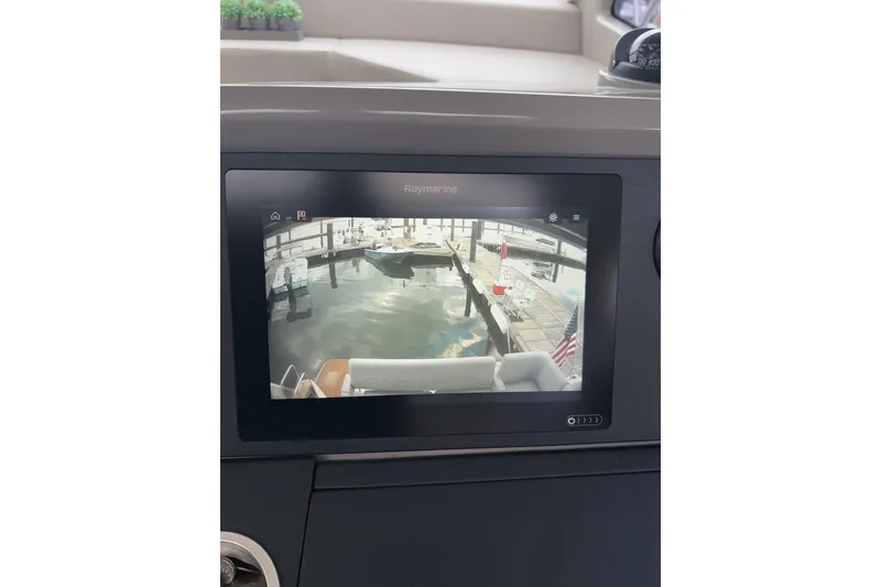 Slide: The Image of 2018 Sea Ray Sundancer 460 dashboard with Raymarine display showing dock view. - 24