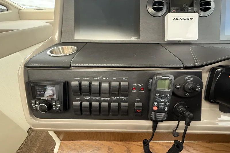 Slide: The Image of Control panel of a 2018 Sea Ray Sundancer 460 yacht with navigation and communication equipment. - 25