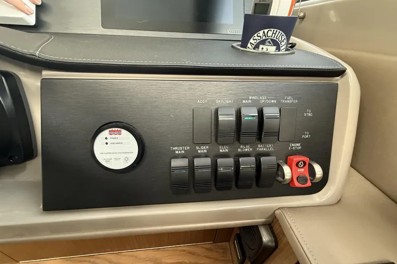 Slide: The Image of Control panel of a 2018 Sea Ray Sundancer 460 yacht with various switches and indicators. - 26