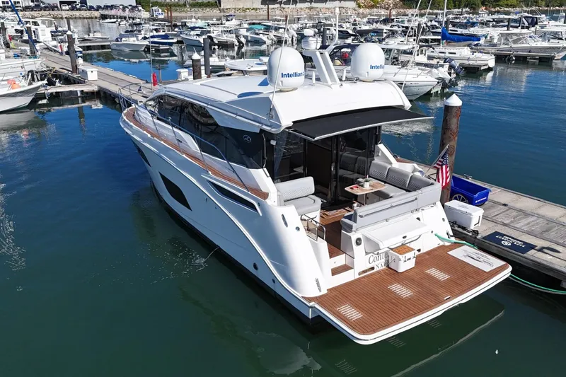 Slide: The Image of 2018 Sea Ray Sundancer 460 yacht docked at marina, featuring sleek design and spacious deck. - 3