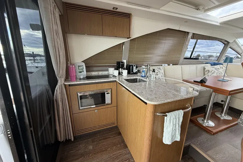Slide: The Image of Interior of 2018 Sea Ray Sundancer 460 yacht with modern kitchen and dining area. - 6
