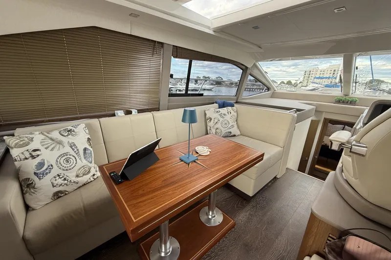 Slide: The Image of Luxurious interior of 2018 Sea Ray Sundancer 460 yacht with elegant seating and wooden table. - 7
