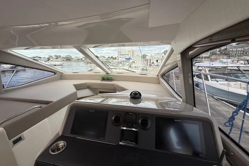 Slide: The Image of 2018 Sea Ray Sundancer 460 yacht interior with modern navigation system and panoramic windows. - 9