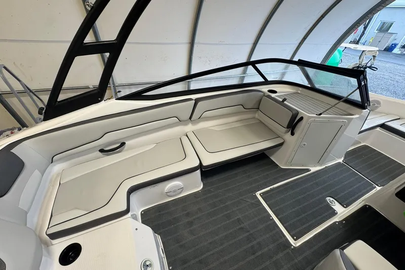 Slide: The Image of 2026 Yamaha Boats AR190 interior with steering wheel and seating in a covered storage area. - 10