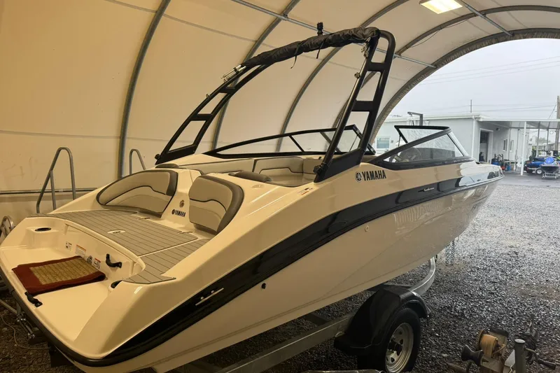 Slide: The Image of 2026 Yamaha AR190 boat in a covered storage area, side view. - 5