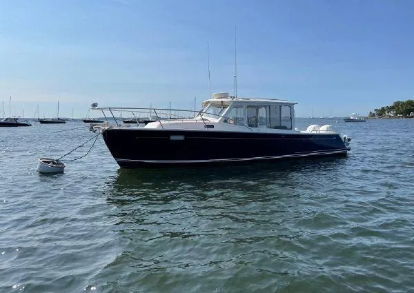 The Image of 2020 MJM 35z boat anchored on calm water under clear blue sky. - 0