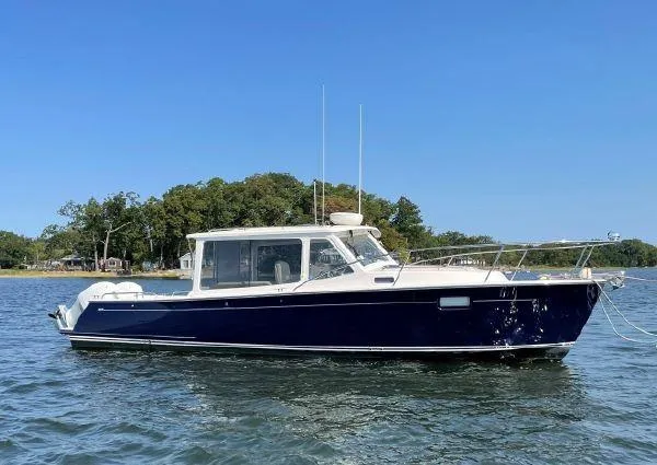 Slide: The Image of 2020 MJM 35z boat on water with clear blue sky and island background. - 1