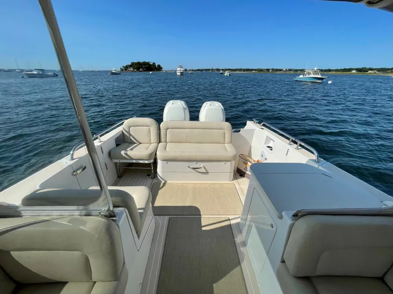 Slide: The Image of 2020 MJM 35z boat interior with seating, overlooking calm waters and distant boats. - 11