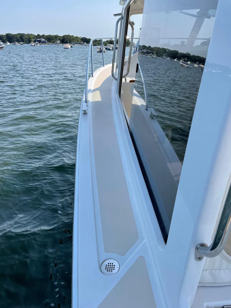 Slide: The Image of 2020 MJM 35z boat on water, side view with clear skies and distant shoreline. - 16