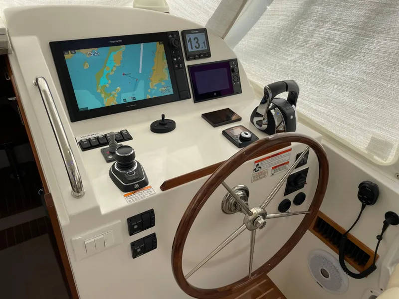 Slide: The Image of Cockpit of 2020 MJM 35z boat with navigation screens and steering wheel. - 18