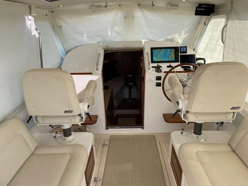 Slide: The Image of Interior of a 2020 MJM 35z boat with helm, seating, and navigation equipment. - 24
