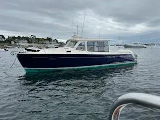 Slide: The Image of 2020 MJM 35z boat on calm water under cloudy sky. - 27