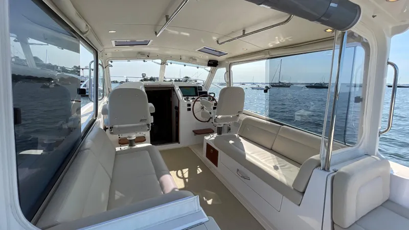 Slide: The Image of Interior of 2020 MJM 35z boat with spacious seating and helm, overlooking the water. - 6