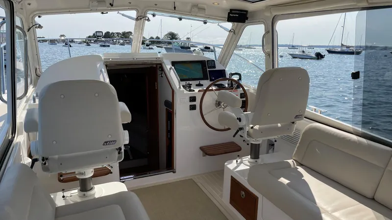 Slide: The Image of Interior of 2020 MJM 35z boat with helm, seating, and ocean view. - 7
