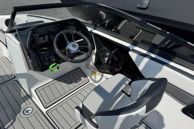 Slide: The Image of 2026 Yamaha Boats 195S cockpit with steering wheel and seating, featuring modern design elements. - 13