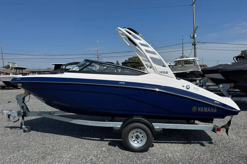 Slide: The Image of 2026 Yamaha Boats 195S on trailer under blue sky. - 2