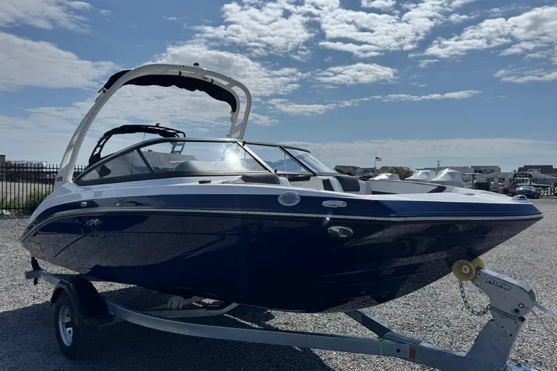 Slide: The Image of 2026 Yamaha Boats 195S, sleek blue and white design, displayed outdoors on a trailer. - 4