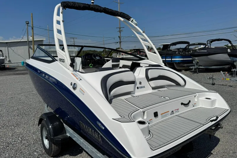 Slide: The Image of 2026 Yamaha Boats 195S on trailer under a partly cloudy sky. - 5