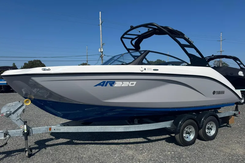 The Image of 2026 Yamaha Boats AR220 on trailer, sleek design under clear blue sky. - 0