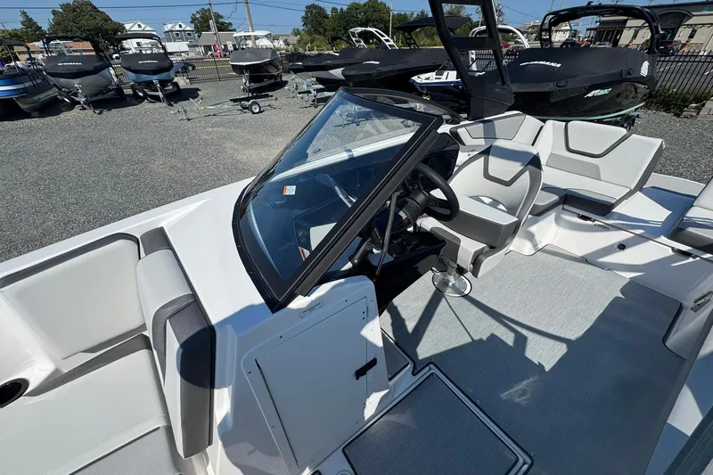 Slide: The Image of 2026 Yamaha Boats AR220 interior seating with gray cushions and cup holders. - 10