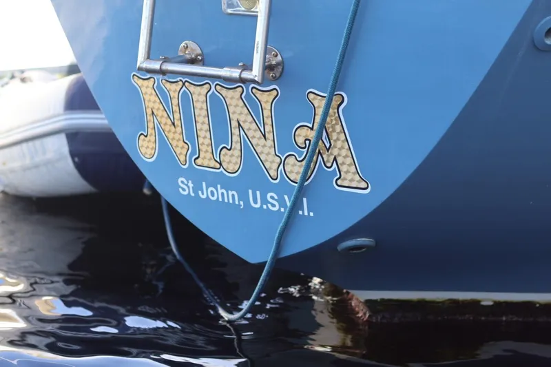 Slide: The Image of Blue C&C Landfall 38 sailboat stern with "NINA" and "St John, U.S.V.I." text. - 14