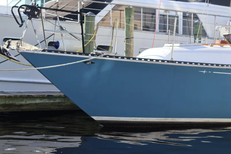 Slide: The Image of 1980 C&C Landfall 38 sailboat docked, featuring a sleek blue hull design. - 16