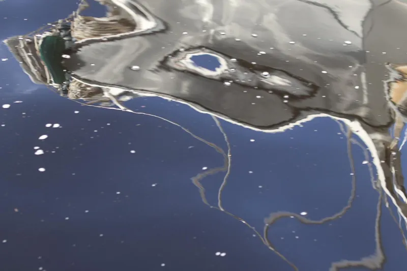 Slide: The Image of Reflection of a C&C Landfall 38 sailboat on water, 1980 model. - 19