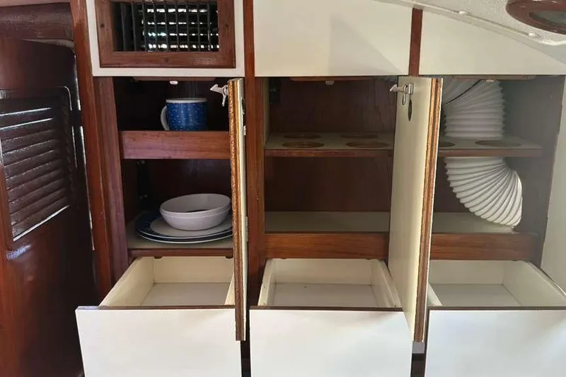 Slide: The Image of Interior of 1980 C&C Landfall 38 sailboat with open cabinets and drawers. - 28