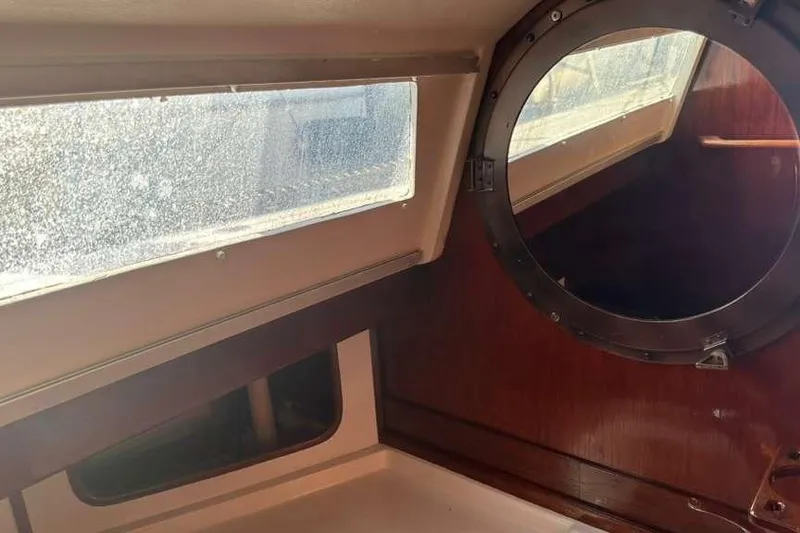 Slide: The Image of Interior of 1980 C&C Landfall 38 sailboat with round porthole and rectangular window. - 31