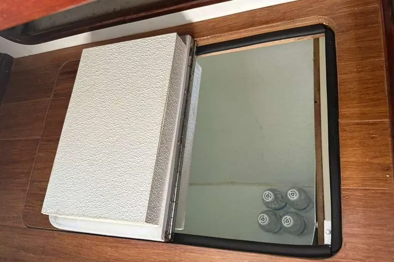 Slide: The Image of Interior of 1980 C&C Landfall 38 yacht with wooden finish and storage compartment. - 34