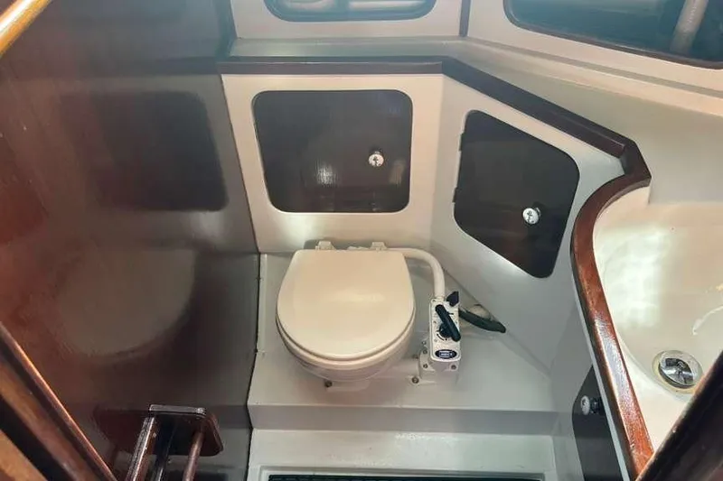 Slide: The Image of 1980 C&C Landfall 38 yacht bathroom with toilet and wooden cabinetry. - 37