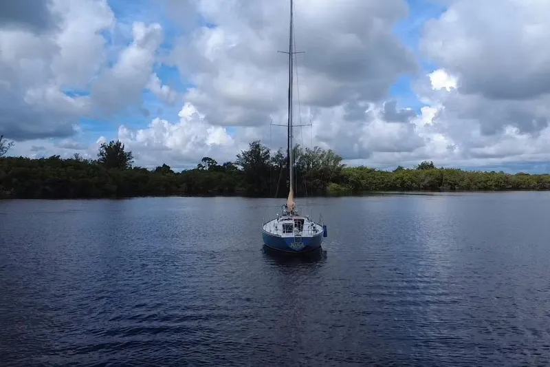 Slide: The Image of 1980 C&C Landfall 38 sailboat on calm water under cloudy sky. - 61