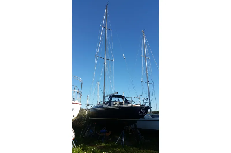Slide: The Image of 1980 C&C Landfall 38 sailboat on land under clear blue sky. - 8