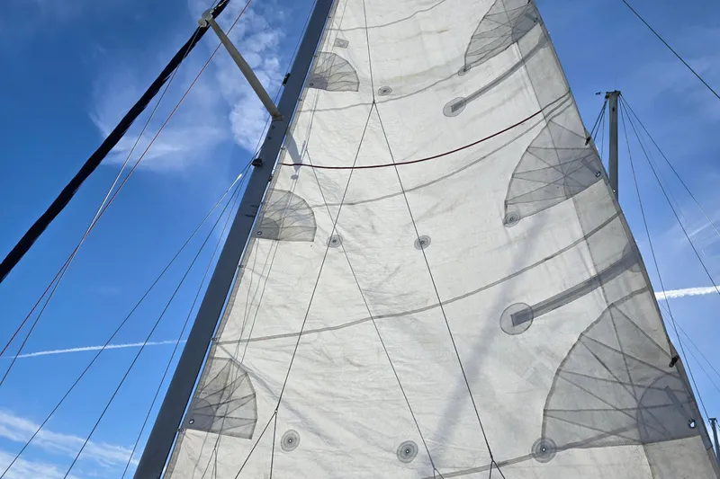 Slide: The Image of Sail of a 1980 C&C Landfall 38 yacht against a clear blue sky. - 9