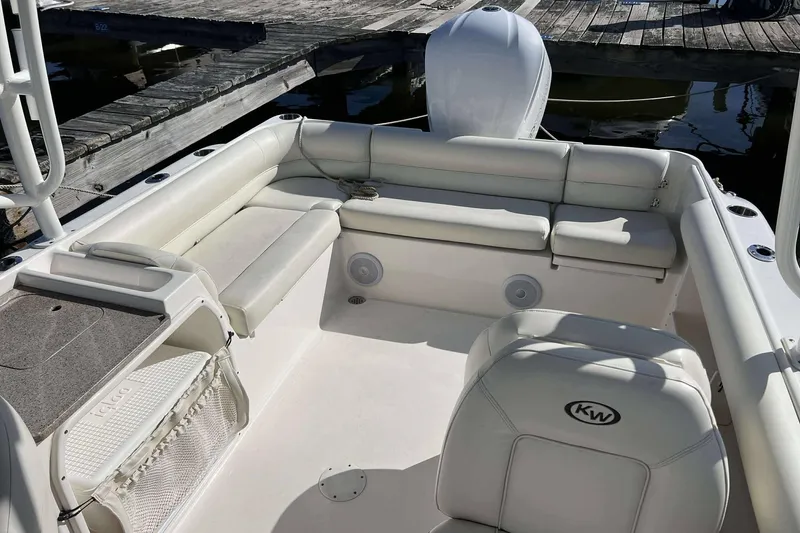 Slide: The Image of 2020 Key West 239 DFS boat interior with white seating and dock background. - 11