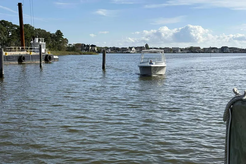 Slide: The Image of 2020 Key West 239 DFS boat on calm water near dock, with scenic shoreline view. - 14